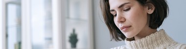Pensive woman looking at mobile
