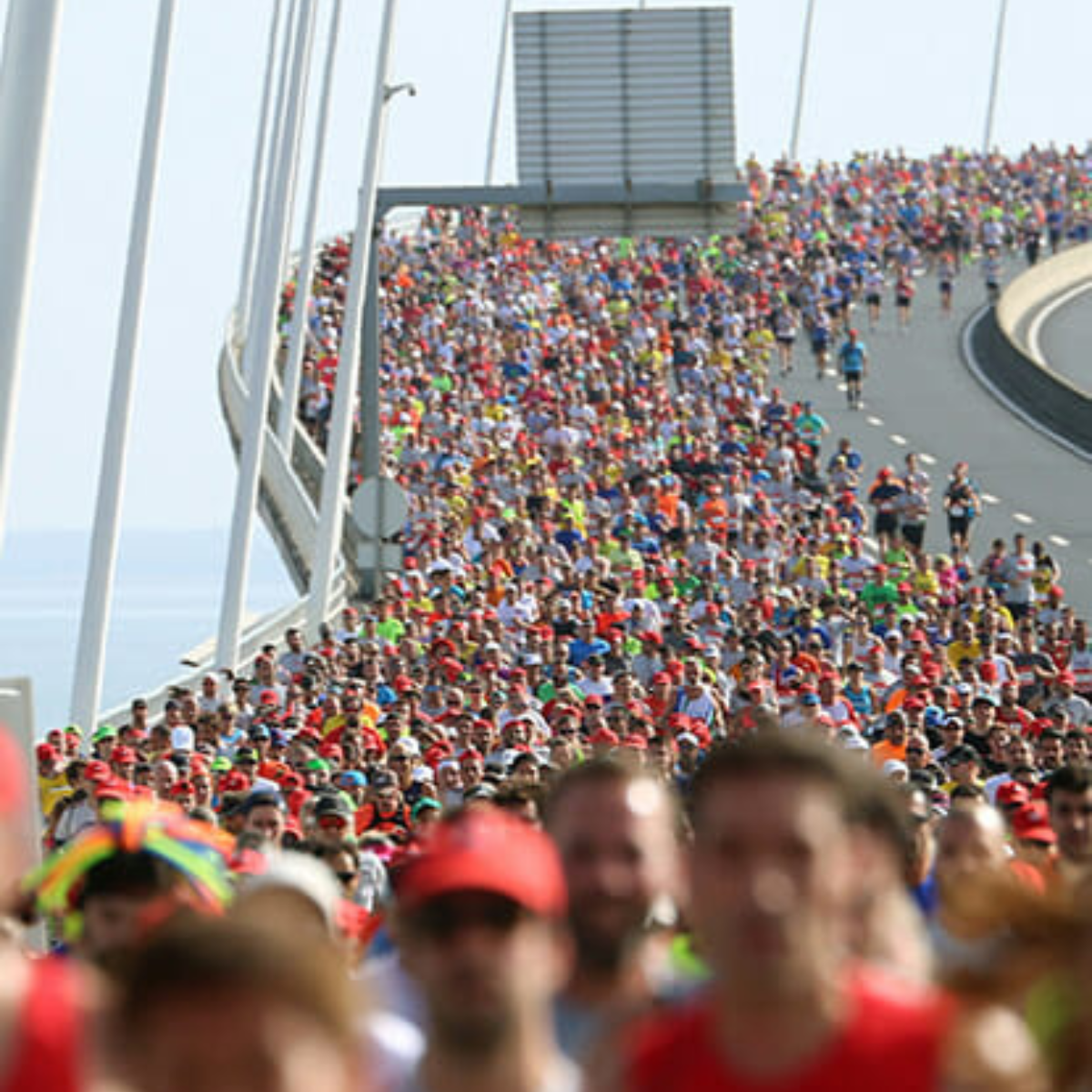 Runners over a bridge in Lisbon