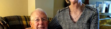 Jackie and her husband sat on an armchair