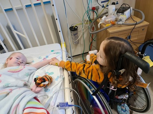 A photo of two children holding hands