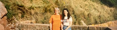 Annette and her mum sat on a wall outside