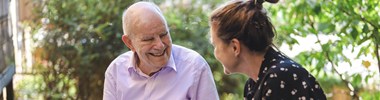 Smiling older man and woman looking at photo album